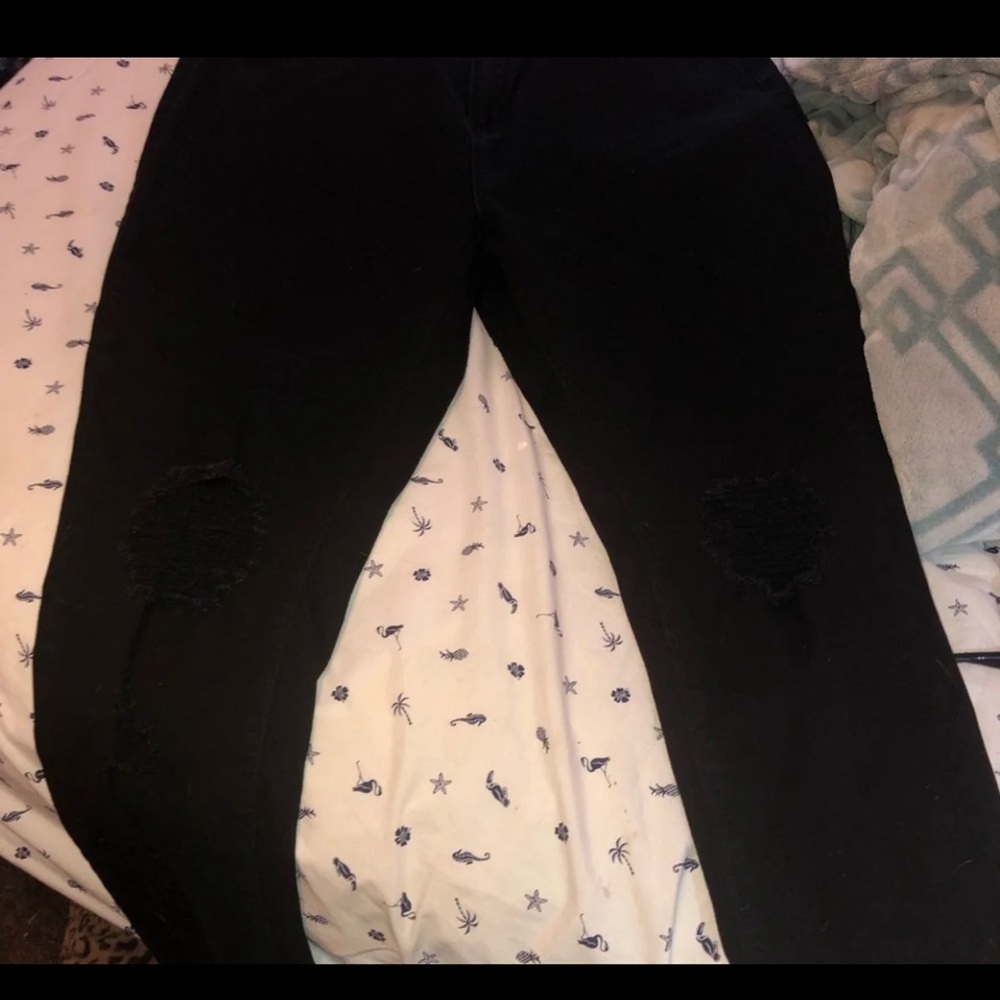 Distressed black jeans.